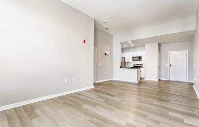 A room with wooden flooring and white walls.