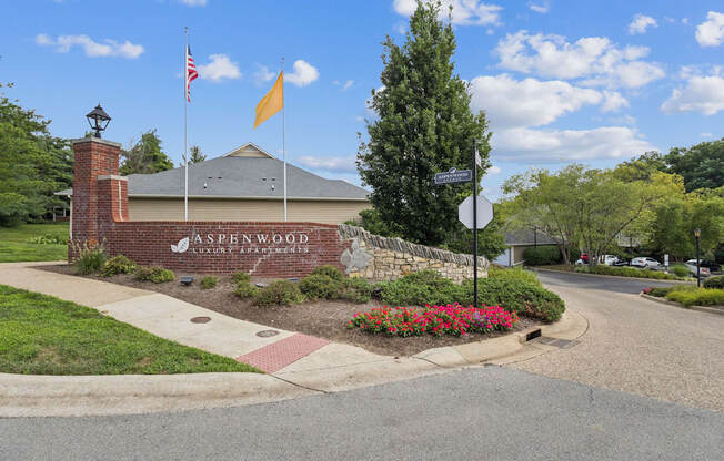 The Aspenwood Luxury Estate sign is displayed on a brick building.