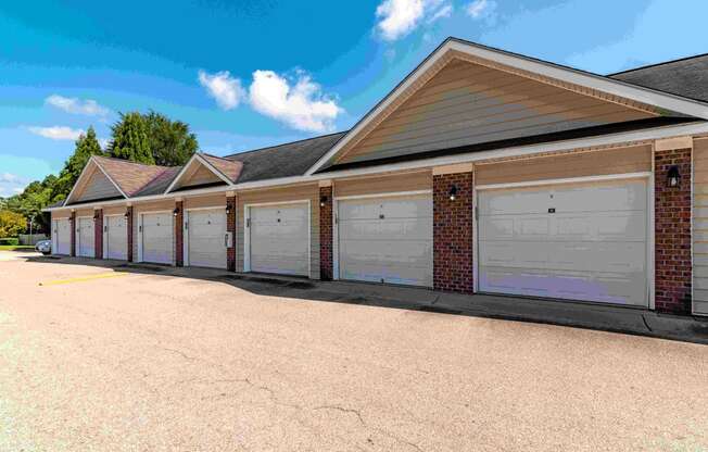 a row of garages with white doors on the side of a building