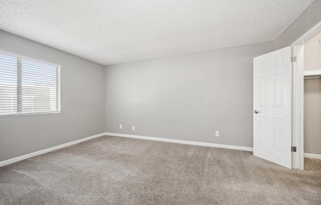 Model room with a carpeted floor and a white door.