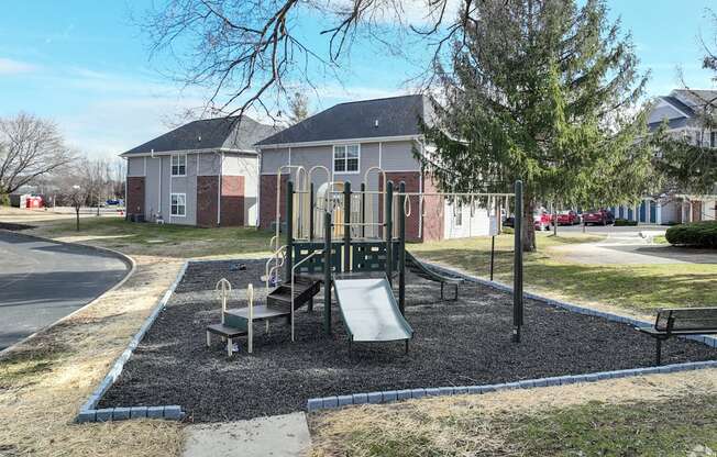 a playground in a park in front of a house