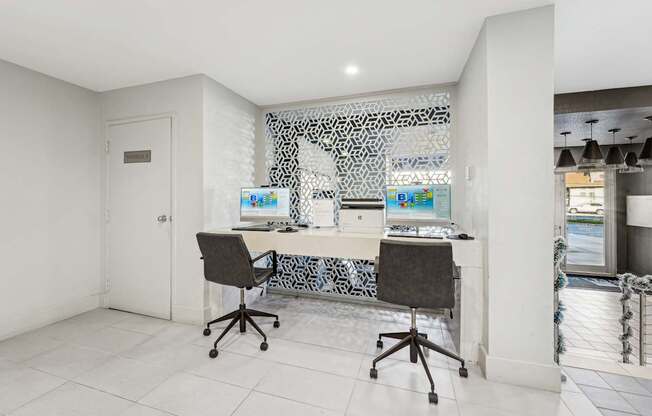 A white room with a desk and chairs.