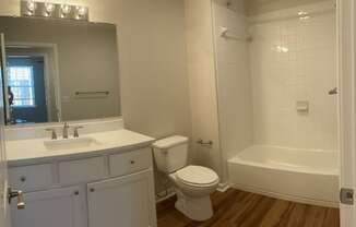 a bathroom with a toilet and a sink and a bath tub