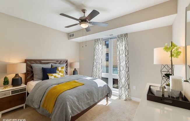 Large Bedroom with a Ceiling Fan and Overhead Lighting