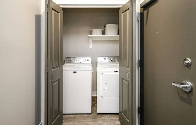 a laundry room with two white machines in it