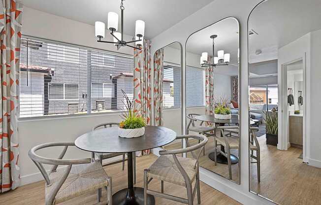 A dining room with a round table and chairs.