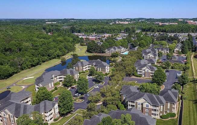 an aerial view of a neighborhood with houses and a pond at Ashford Green, NC 28262