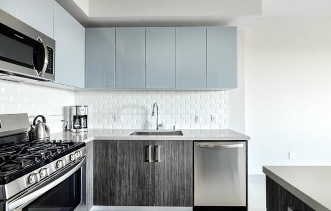 Kitchen with White Tile Backsplash at The Mansfield at Miracle Mile, California