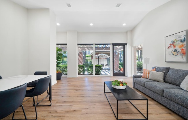 a living room with a couch and a table with chairs
