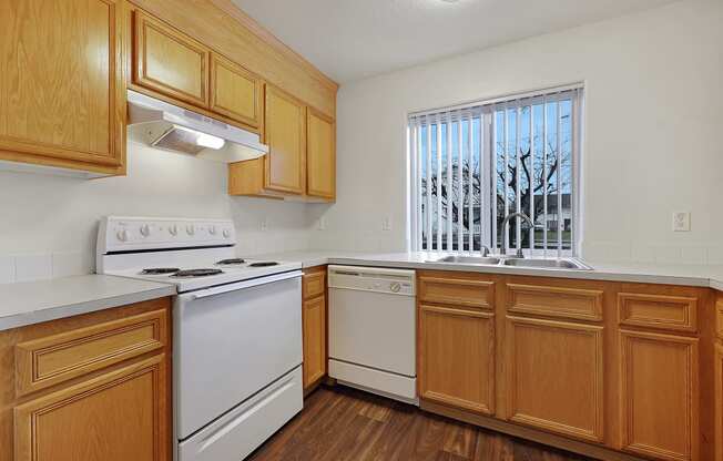 a kitchen with wood cabinets and white appliances