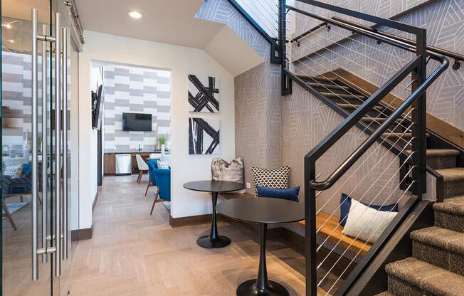 a living room with a staircase and a glass door