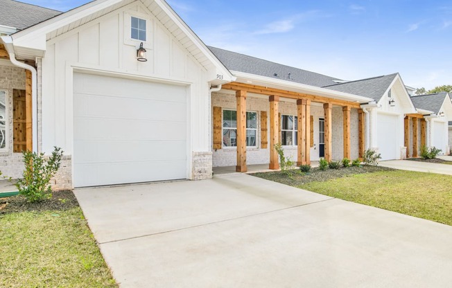 a white house with a driveway and a garage door