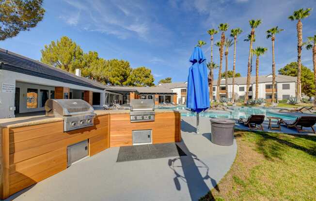 a backyard with an outdoor kitchen and pool