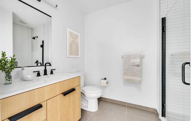 A bathroom with a white toilet and a white sink.