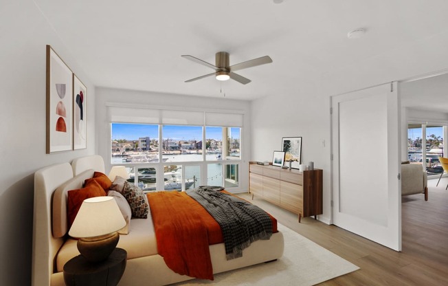 an apartment bedroom with a bed and a ceiling fan
