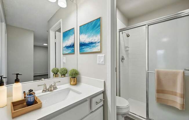 A bathroom with a white toilet and a white sink.