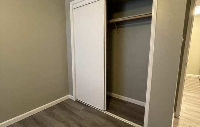 a bedroom with a closet and a door that is open