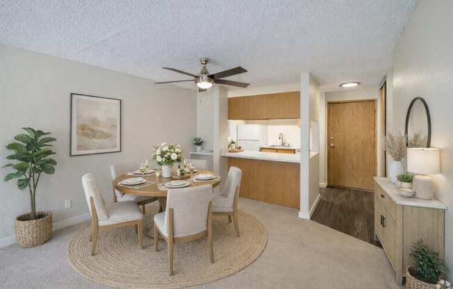 A dining room with a round table and chairs.