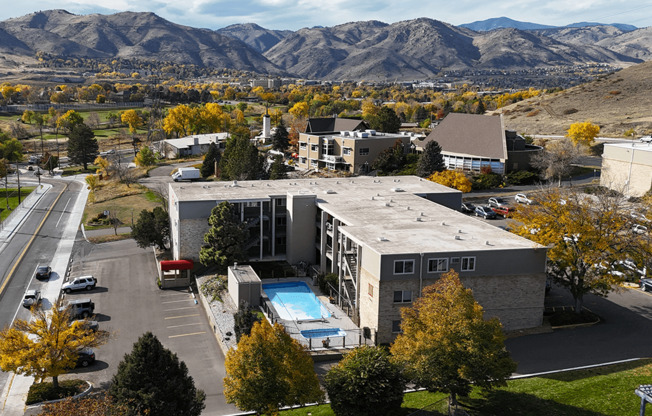 A large building with a pool in the middle of a parking lot.