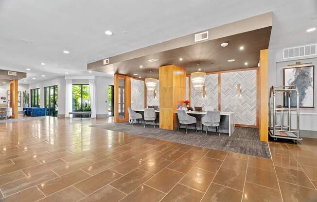 A spacious lobby with a marble floor and a reception desk.