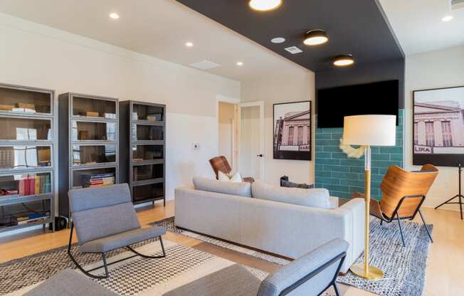 a living room with couches chairs and a bookshelf