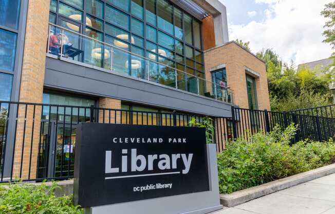 a sign in front of a building with a library