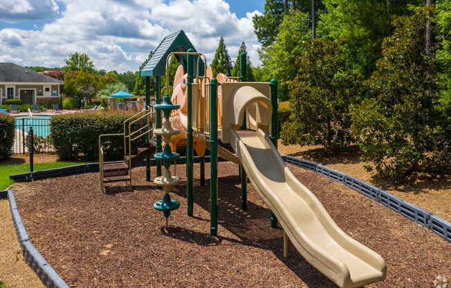 A playground with a slide and a climbing structure.