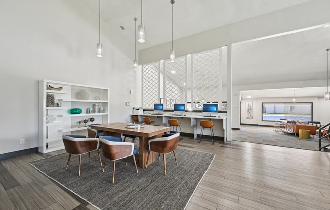 A modern dining room with a wooden table and chairs.