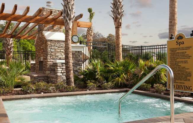 A pool with a diving board and a sign that says Spa.