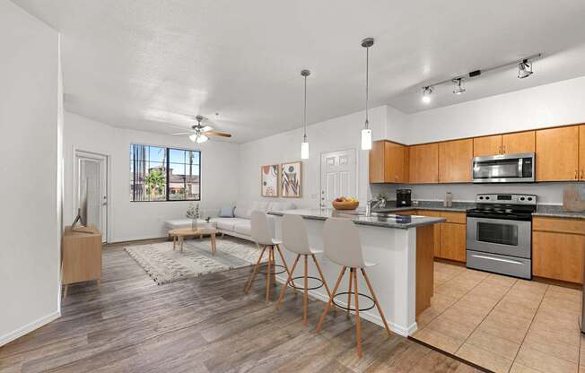 A kitchen with a dining table and chairs in the middle of the room.