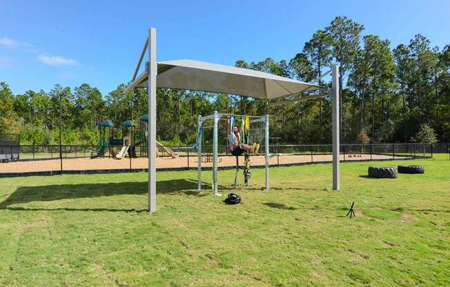 a person on a swing set in a park at Luxor Club, Jacksonville