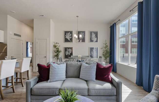 a living room and dining room with a couch and a table and chairs