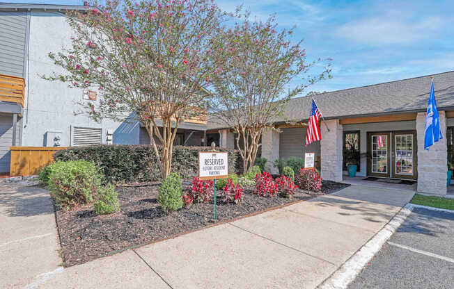 Entrance to our leasing office with a US flag at The Marq apartments in Shreveport, LA