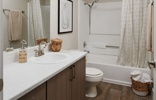 a bathroom with a toilet sink and bathtub in a 555 waverly unit