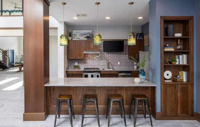 A kitchen with a bar area and a television mounted above the island.