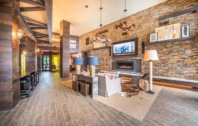 Lounge Area With Stone Fireplace at Aviator West 7th, Fort Worth