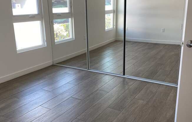 Apartment bedroom with mirrored closet doors