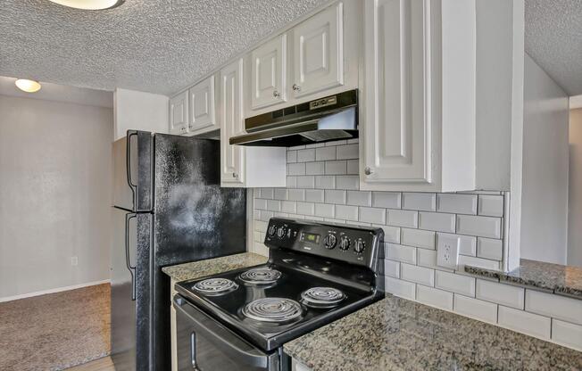 a stove top oven sitting inside of a kitchen