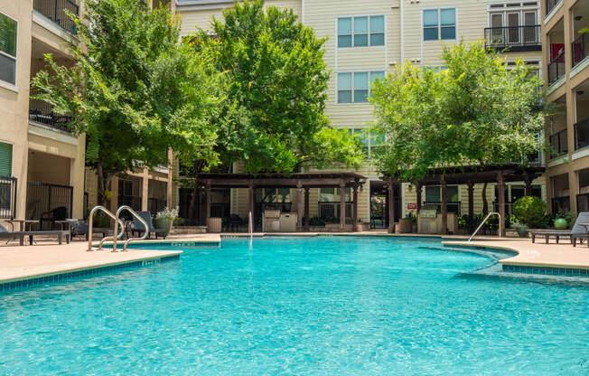 a swimming pool with a building in the background