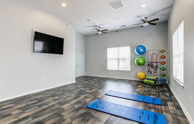 Yoga studio with yoga mats and TV at Avenues at Craig Ranch apartments for rent