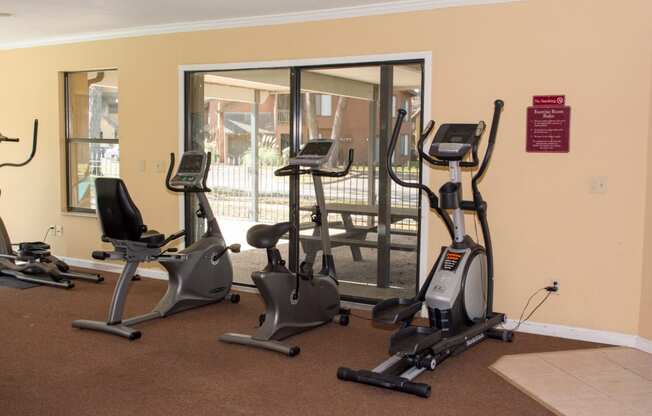 Gym with three Elliptical machines at Laurel Grove Apartment Homes, Florida, 32073