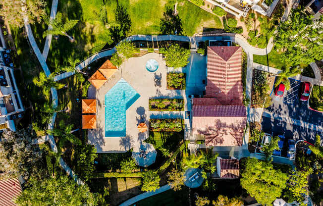 An aerial view of a house with a pool in the backyard.