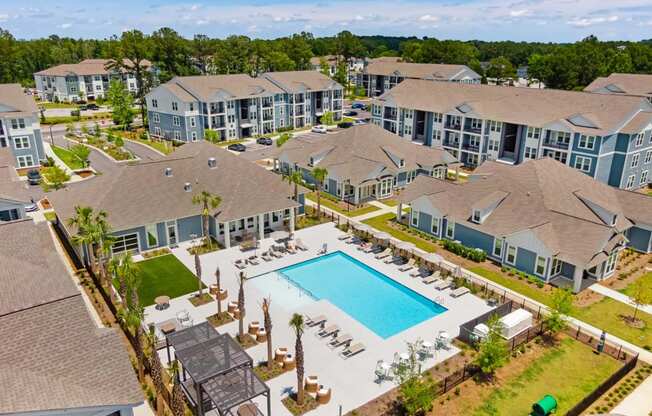 an aerial view of an apartment complex with a swimming pool