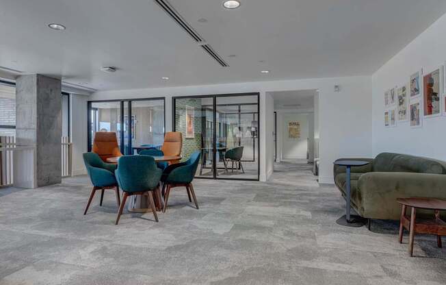A living room with a grey carpet and a green sofa.