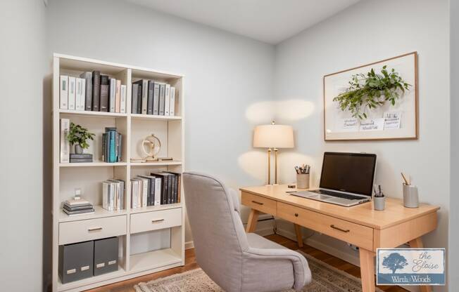 a home office with a computer desk and a bookshelf