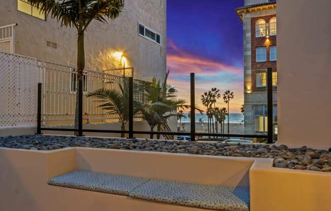 the view of the ocean from the balcony of a condo at sunset