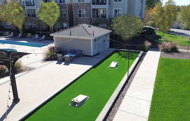 Outdoor entertainment area with cornhole