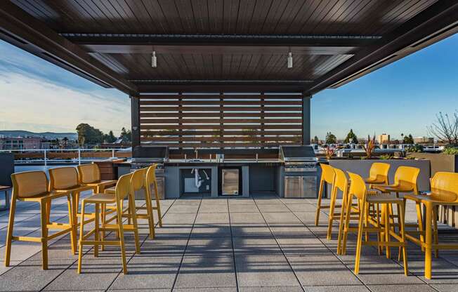 Rooftop Grill Area With Wood-Style Seating, City Views, And Gazebo-Style Covering. at Bayswater Apartments, Burlingame, CA