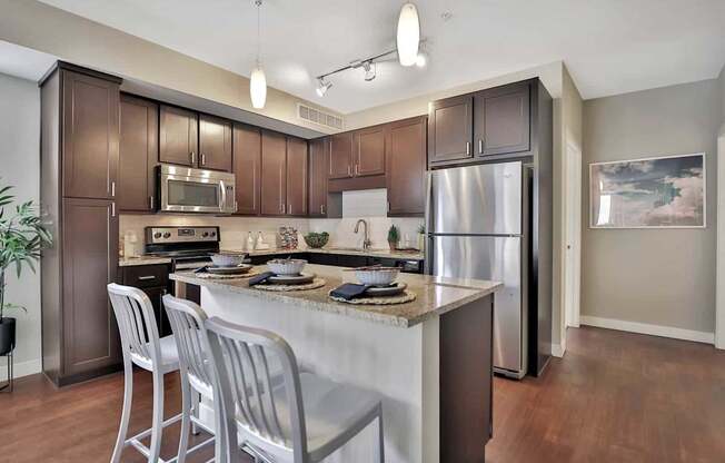 A kitchen with brown cabinets and a white island.