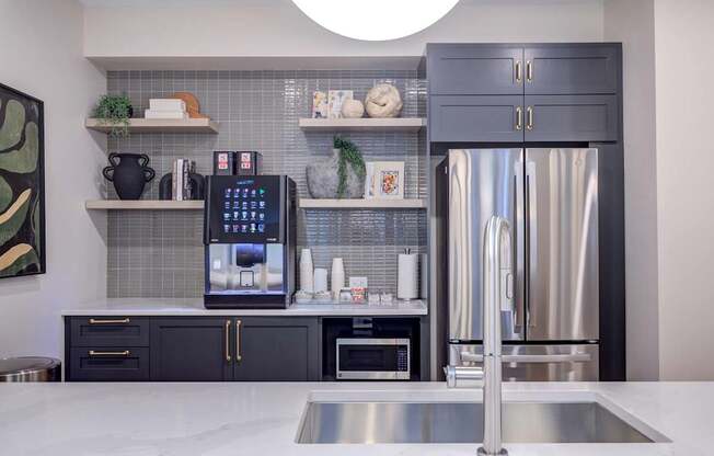 A modern kitchen with a stainless steel refrigerator and a digital ice maker.